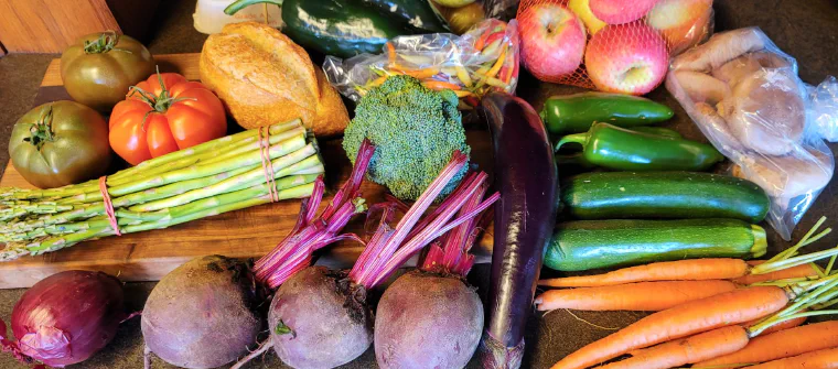 A summer bounty of vegetables, fruit, mushrooms, and bread